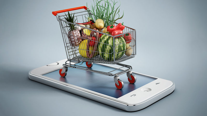 carrinho de compras em cima de um telemóvel